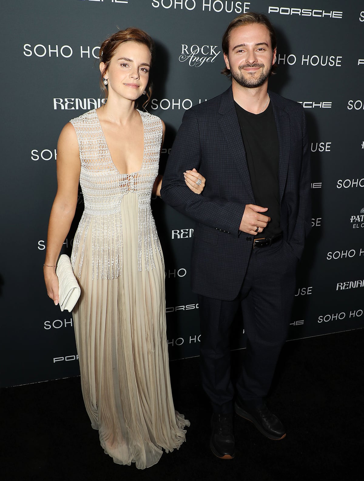 Emma Watson poses with her brother Alex Watson, who looks dapper in a navy suit and a black crewneck tee