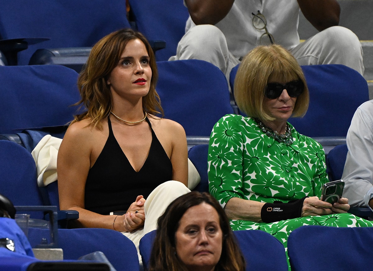 Emma Watson adds a splash of color to her black-and-white outfit with a swipe of bold red lipstick