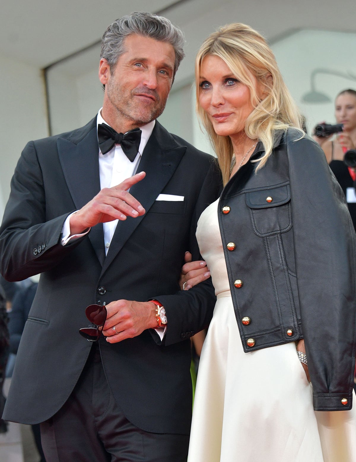 Jillian Fink teams her classic ivory dress with a bold Celine lambskin leather blouson jacket