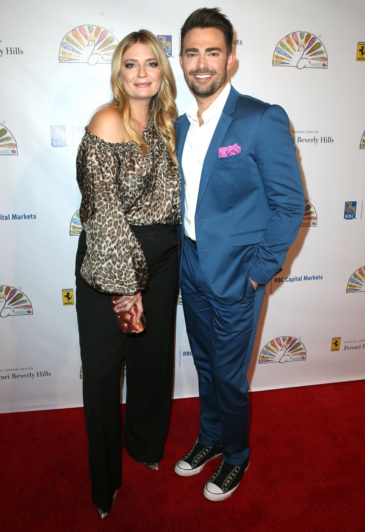 Mischa Barton pairs a chic off-the-shoulder leopard print top with black trousers and pointed-toe heels, while Jonathan Bennett adds a playful touch to his sleek blue suit with black high-top sneakers