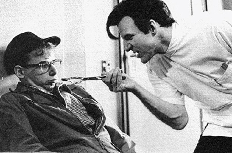 Steve Martin as sadistic, nitrous oxide-addicted dentist Orin Scrivello and Rick Moranis as nerdy florist Seymour Krelborn in the 1986 horror comedy musical Little Shop of Horrors