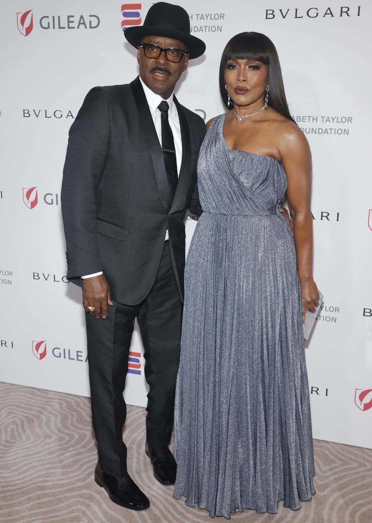 Courtney B. Vance looking snazzy in his suit next to his stunning wife Angela Bassett