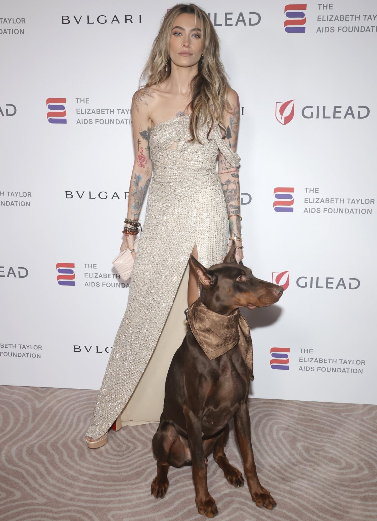 Paris Jackson making a shimmering entrance with canine companion Koa at the Elizabeth Taylor Ball to End AIDS