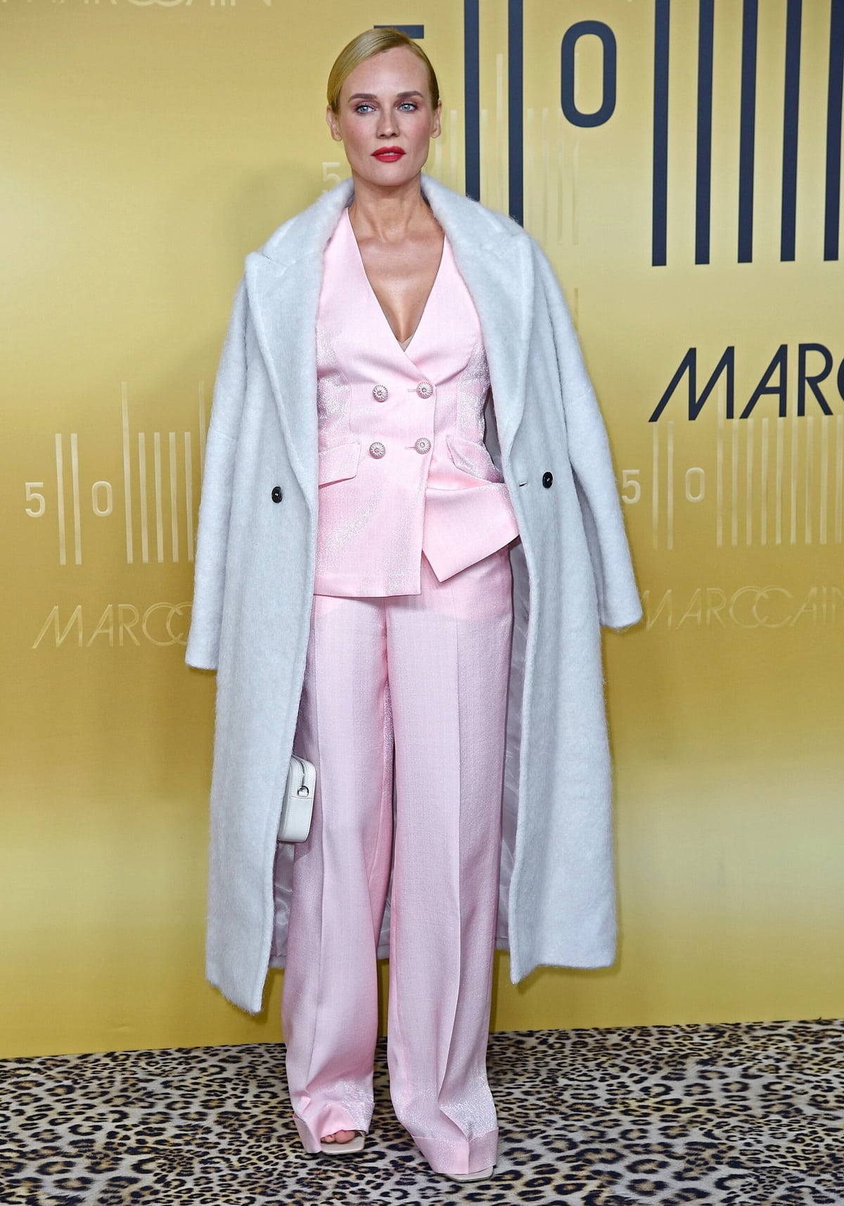 Diane Kruger looking elegant in a pink waistcoat and matching flared pants during the Marc Cain 50th anniversary fashion show event
