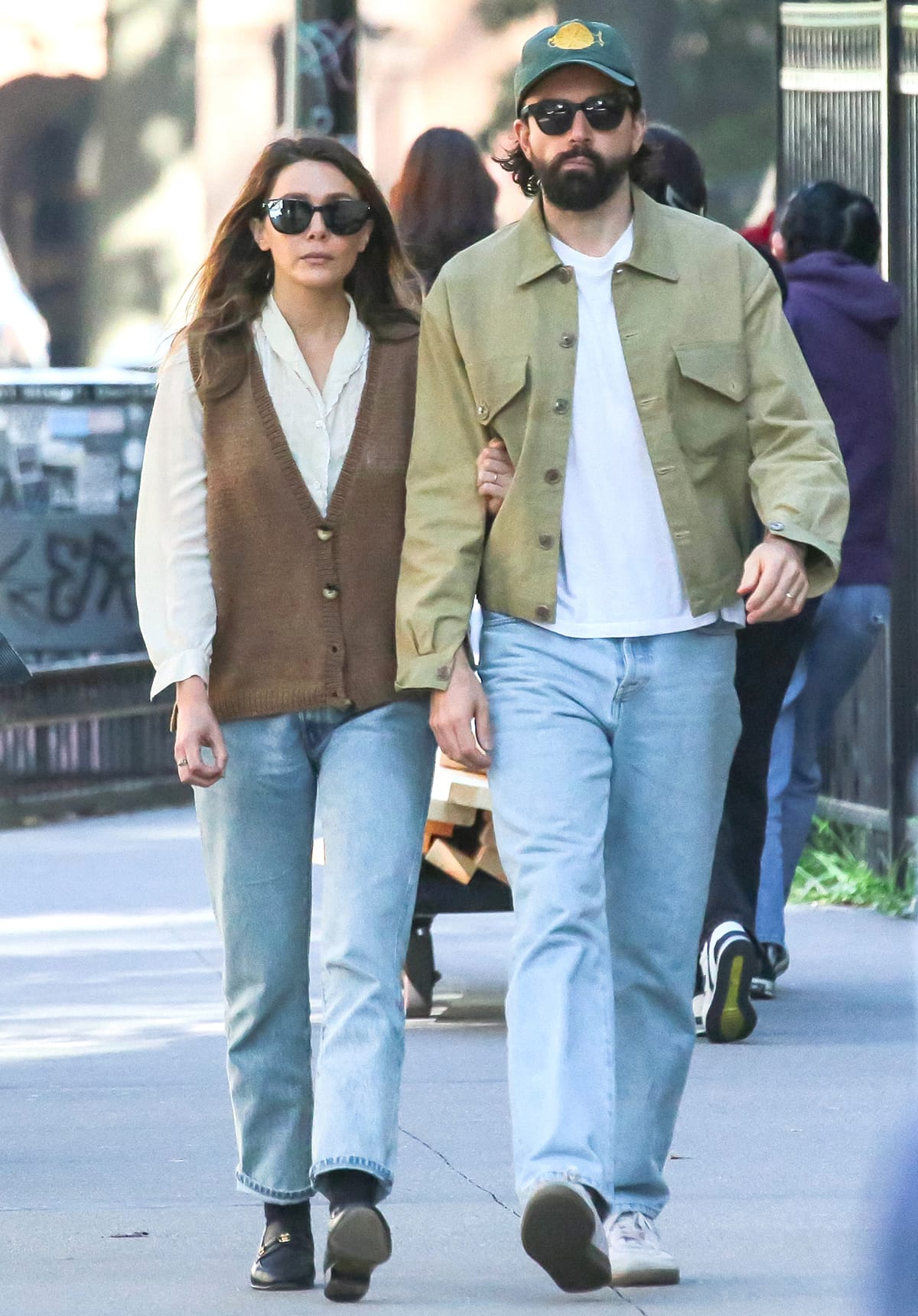 Elizabeth Olsen and Robbie Arnett walking arm-in-arm after grabbing breakfast at Librae Bakery in New York City on October 25, 2023