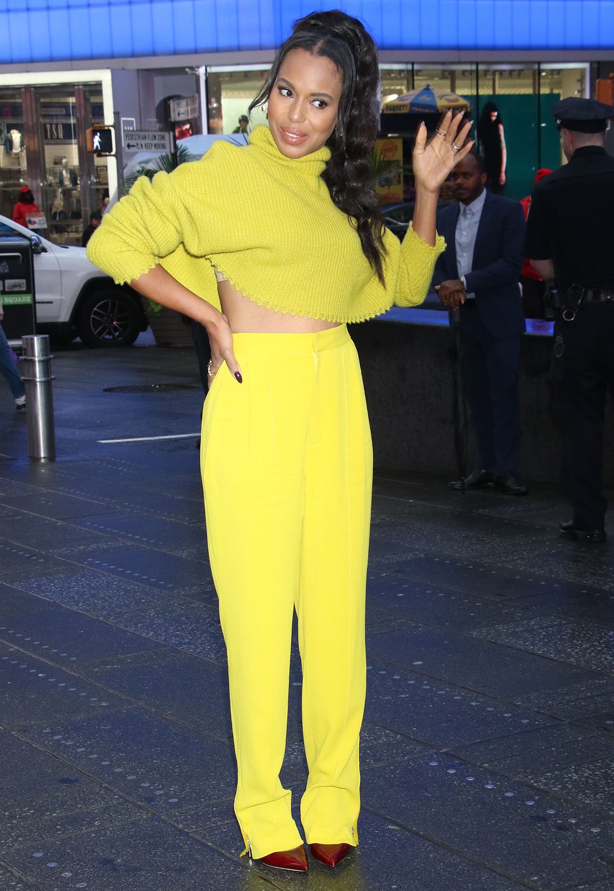 Kerry Washington looks like a ray of sunshine in a chartreuse turtleneck crop sweater and bright yellow high-waist trousers in Time Square for a photo shoot for her new memoir on September 26, 2023