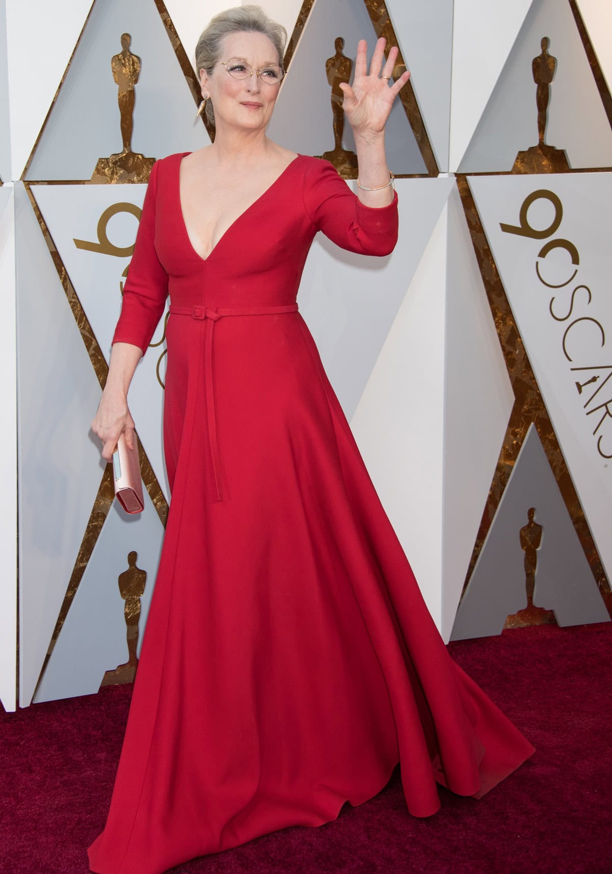 Meryl Streep radiates timeless elegance in a rich red Dior Couture gown with a coordinating fabric belt and Fred Leighton jewels as she celebrates her Best Actress nomination for The Post at the 2018 Oscars