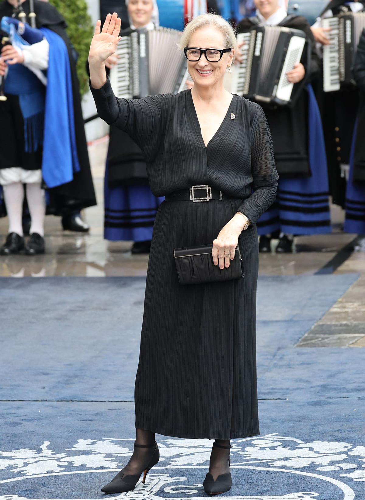 Meryl Streep embraces quiet luxury in a black plissé dress, black tights, and black heels