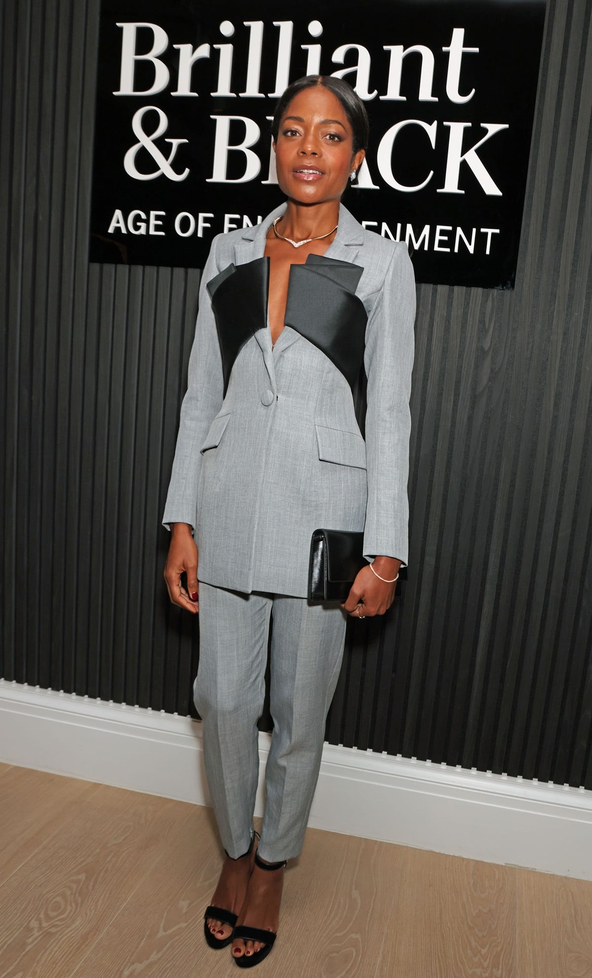 At 5ft 7 (170.2 cm), Naomie Harris radiated elegance in a tailored grey suit during the preview cocktail reception for 