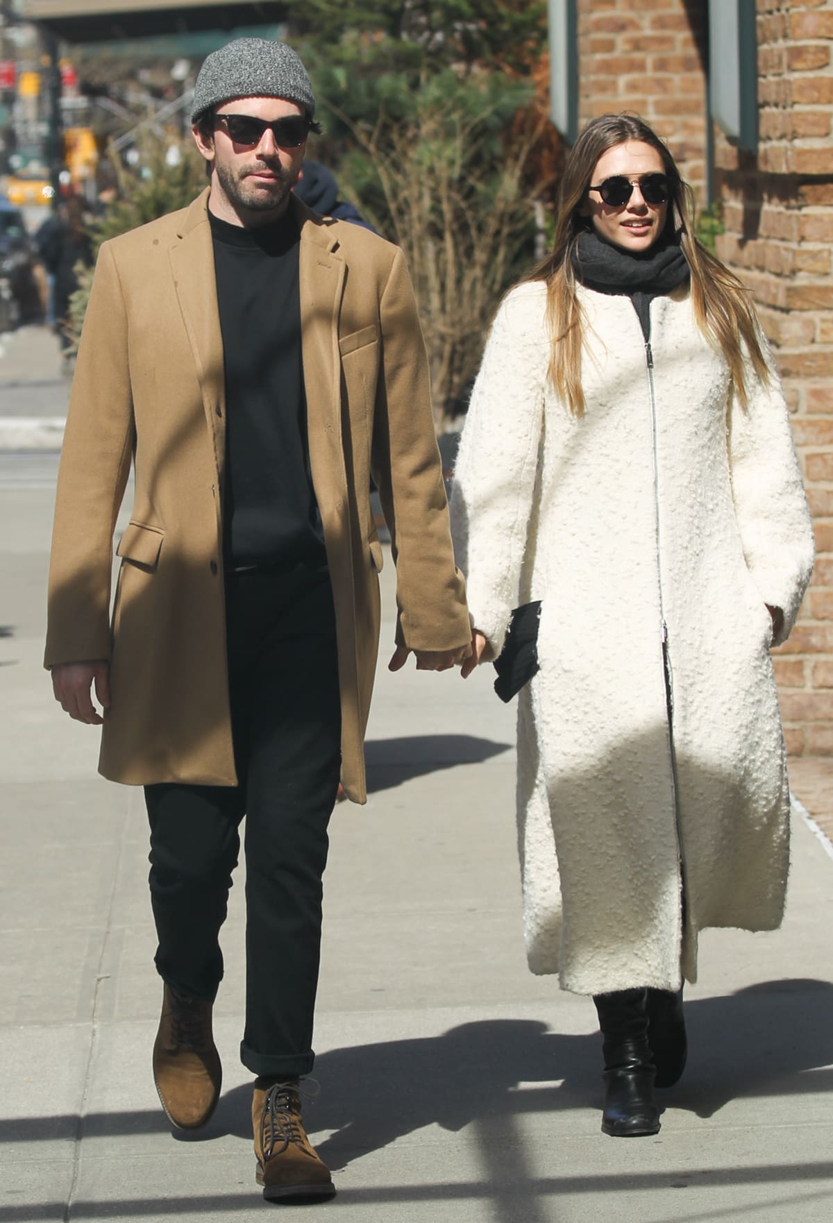 Robbie Arnett and Elizabeth Olsen hold hands while strolling around New York City on March 20, 2017, a month after they first met in Mexico