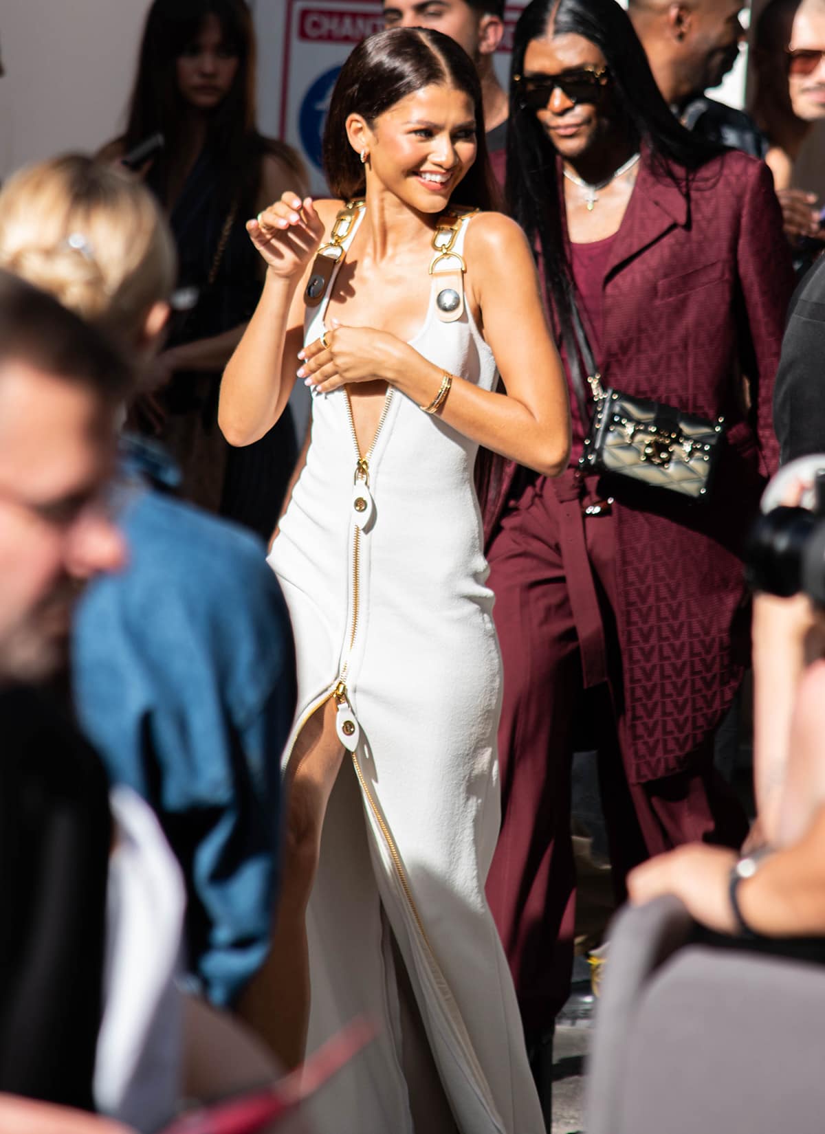 Zendaya turns heads in a white Louis Vuitton dress with two-way gold zips that create a plunging neckline and a thigh-high slit at the French luxury fashion house's Paris Fashion Week Womenswear Spring/Summer 2024 presentation on October 2, 2023