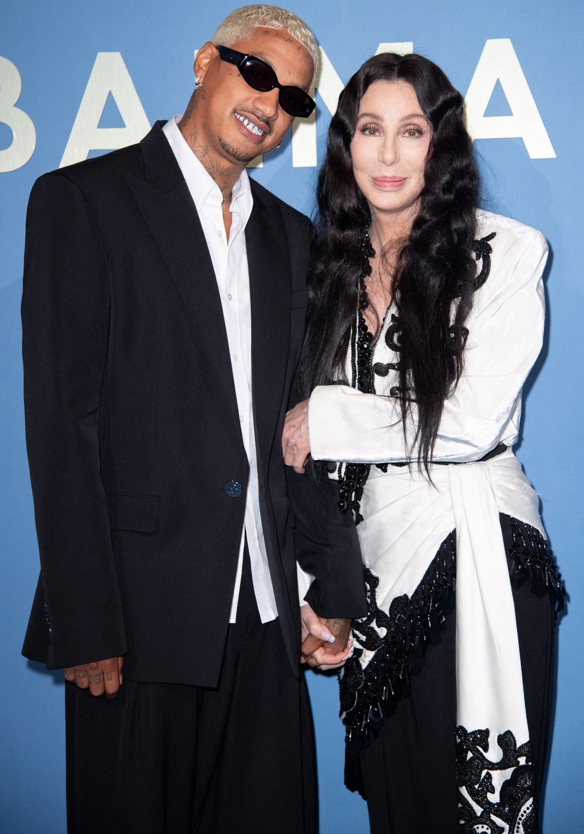 Alexander “AE” Edwards and Cher subtly confirming rekindled romance as they cozied up to each other at the Balmain Spring/Summer 2024 runway show during Paris Fashion Week
