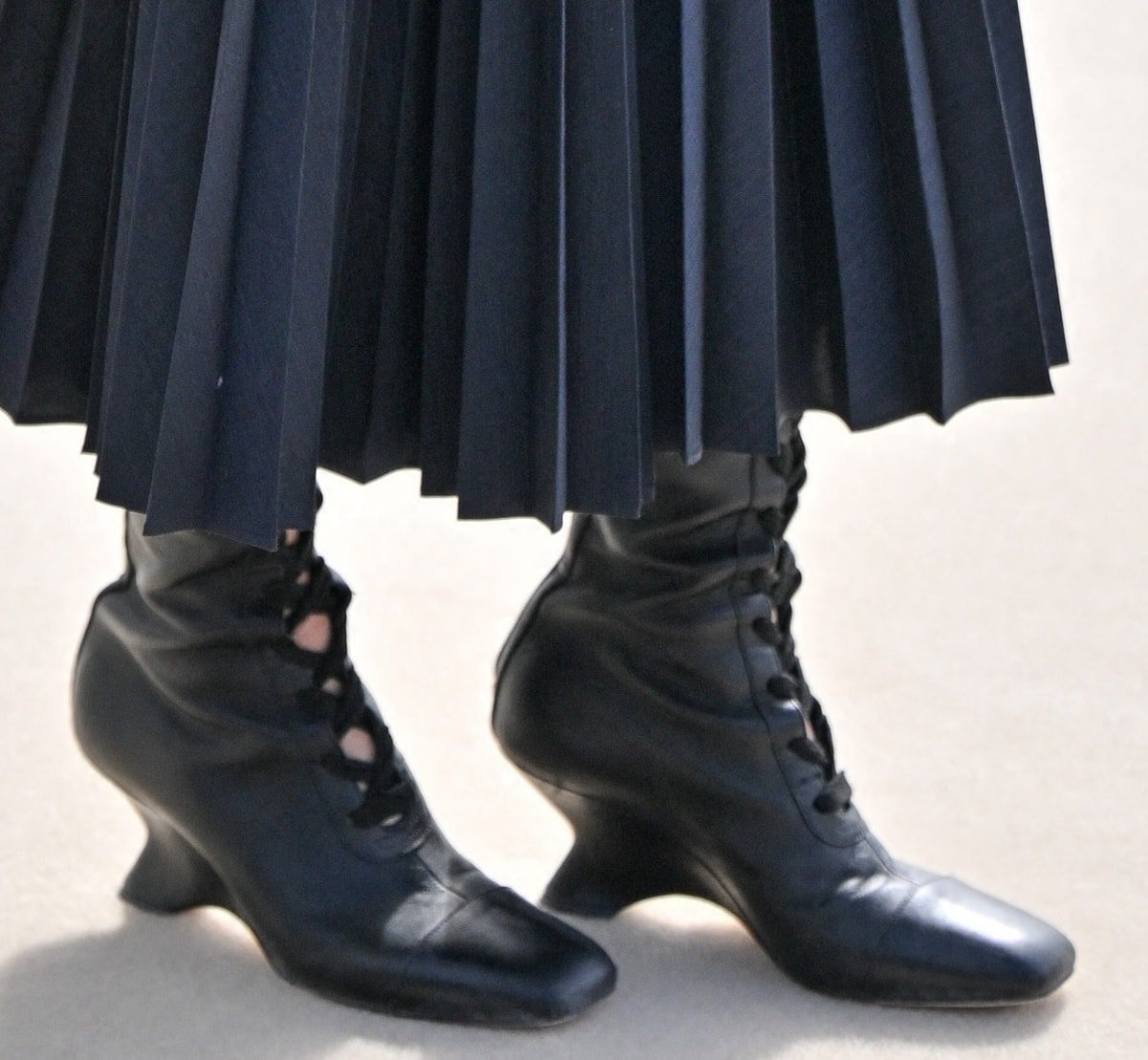 Jenna Ortega wearing black lace-up boots for a witchy vibe that complemented her business goth aesthetic