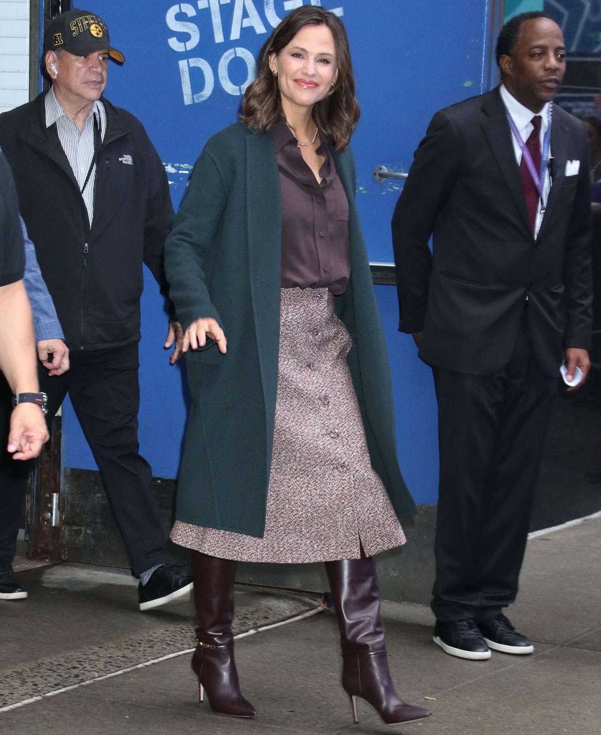 Jennifer Garner wearing a pair of brown knee-high boots to complement her fall-themed ensemble