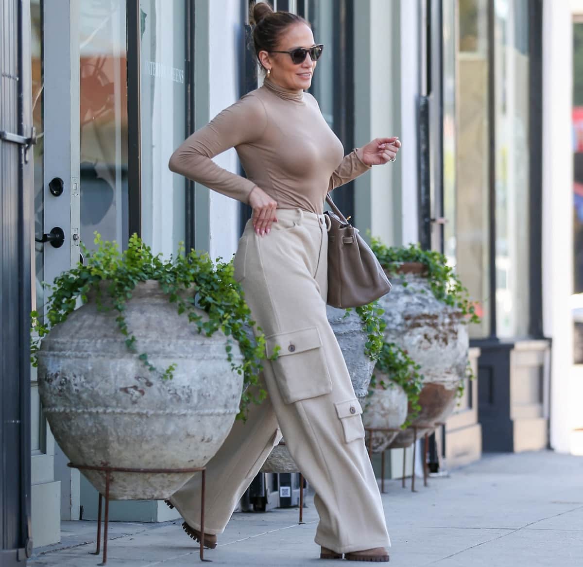 Jennifer Lopez was seen indulging in retail therapy while effortlessly showcasing a cozy autumn style in a striking camel-colored outfit