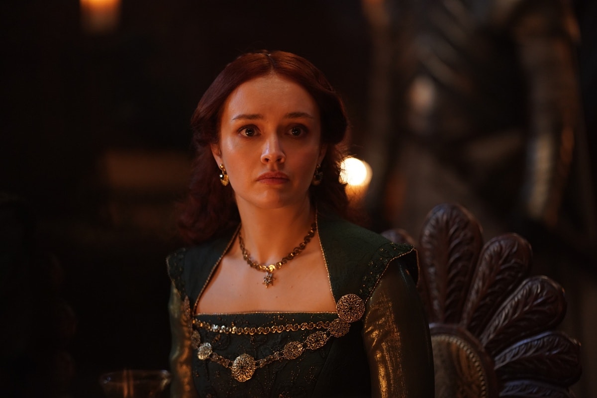 Olivia Cooke as Alicent Hightower in House of the Dragon, wearing a regal emerald gown with gold embellishments and period jewelry that reflect her character’s rising political influence