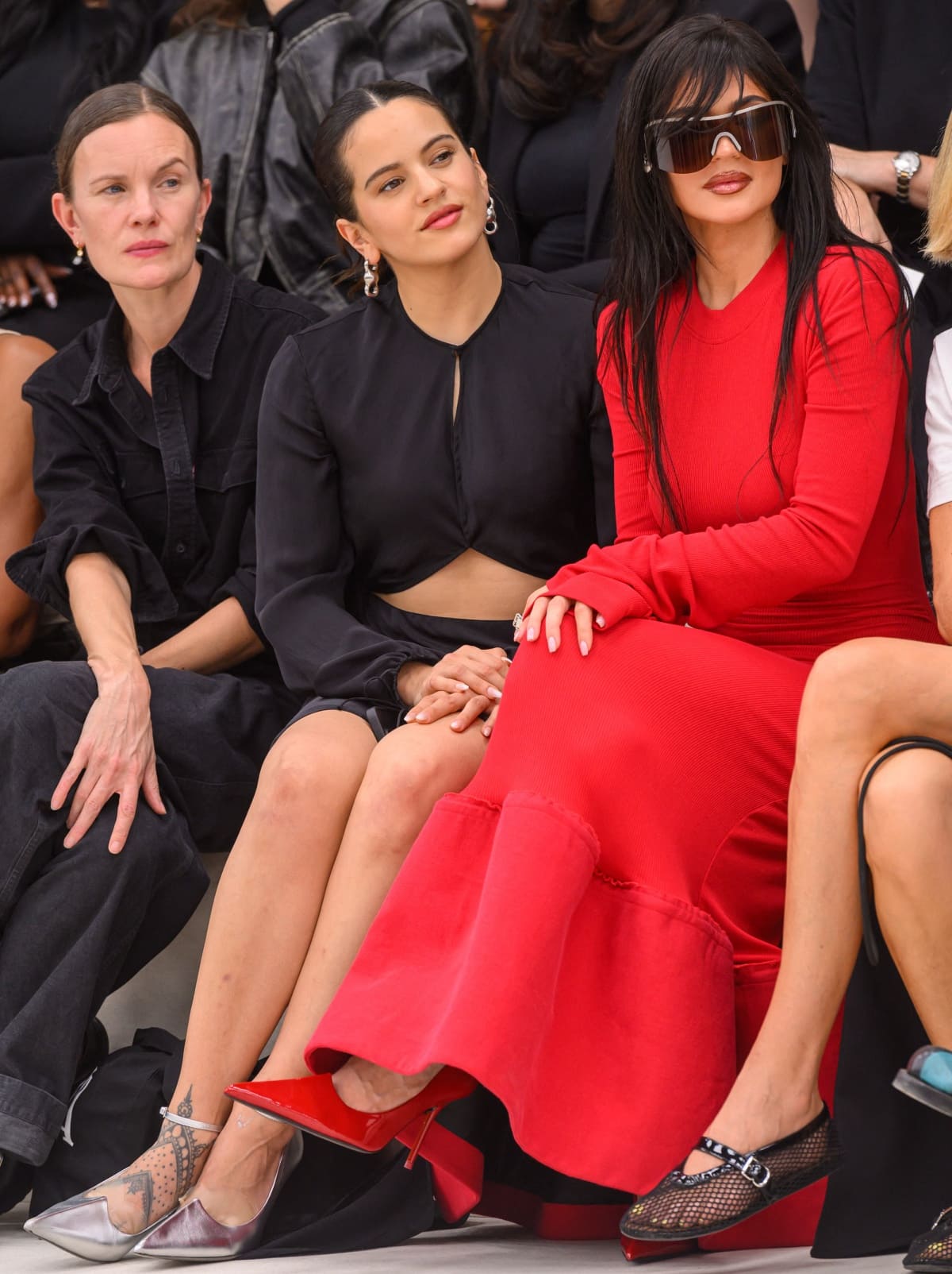 Rosalia and Kylie Jenner watching the Acne Studios Spring/Summer 2024 fashion show in the front row