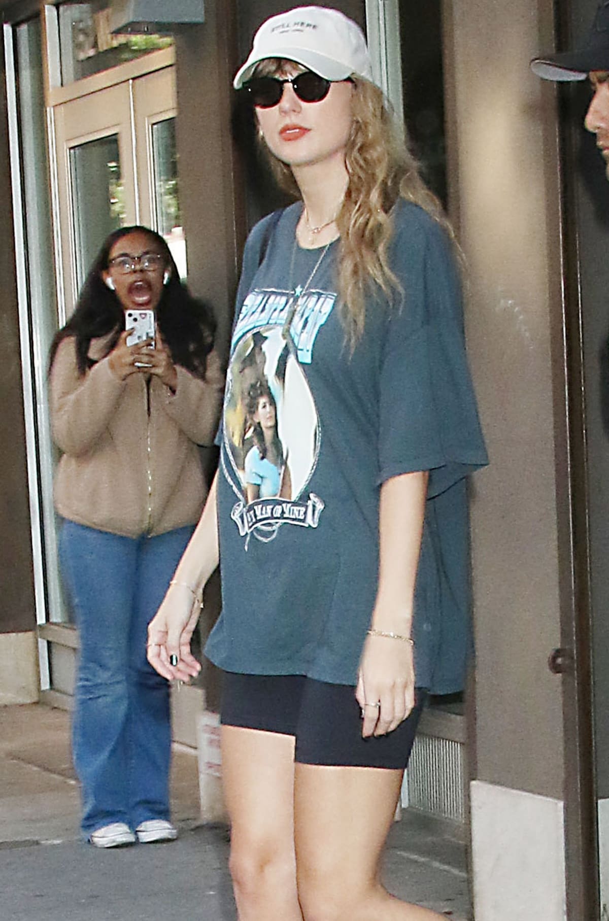 Taylor Swift wearing an oversized T-shirt from Free People featuring a graphic of Shania Twain’s hit song “Any Man of Mine”