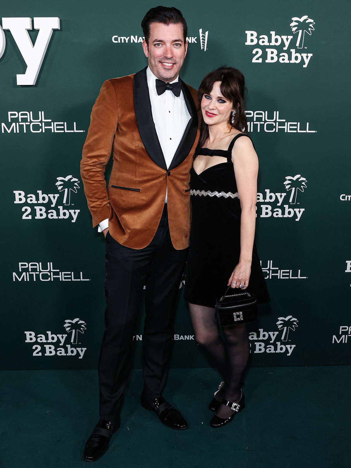 Jonathan Scott and Zooey Deschanel show their fun take on red-carpet dressing at the 2023 Baby2Baby Gala on November 11, 2023