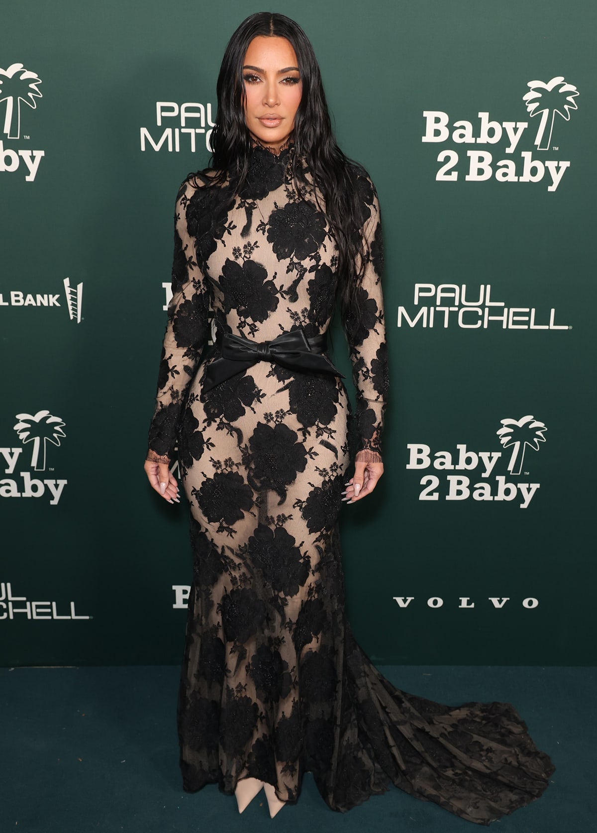 Kim Kardashian embraces gothic glamour in a see-through black floral lace dress by Balenciaga with a nude bodysuit and pantaboots underneath