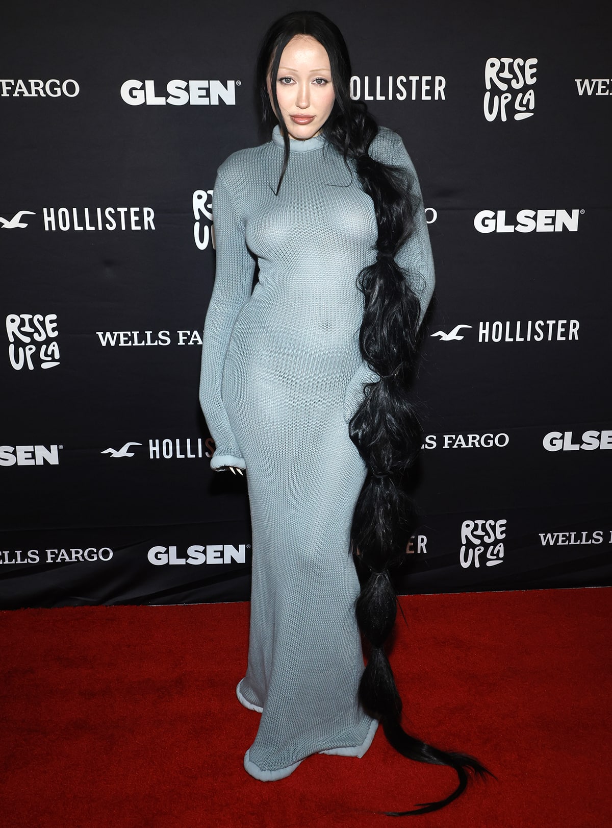 Noah Cyrus turns heads in a form-fitting aqua gray knit dress by Colors Clothing Company at GLSEN’s Rise Up LA Benefit Gala held at NeueHouse Hollywood on October 29, 2023