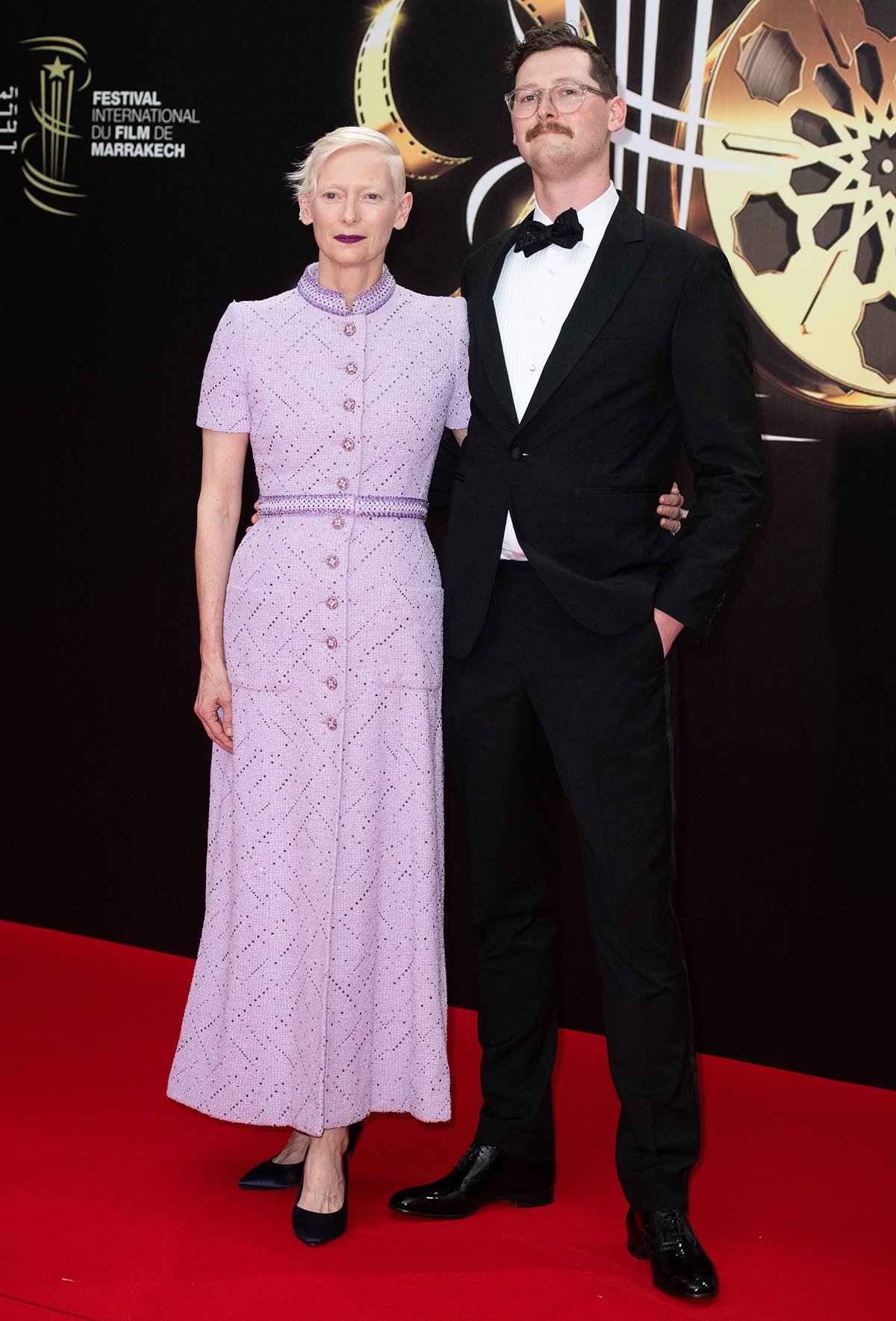 Tilda Swinton is accompanied by her son Xavier Swinton Byrne to the event, clad in a traditional tuxedo with a bow-tie and white shirt.