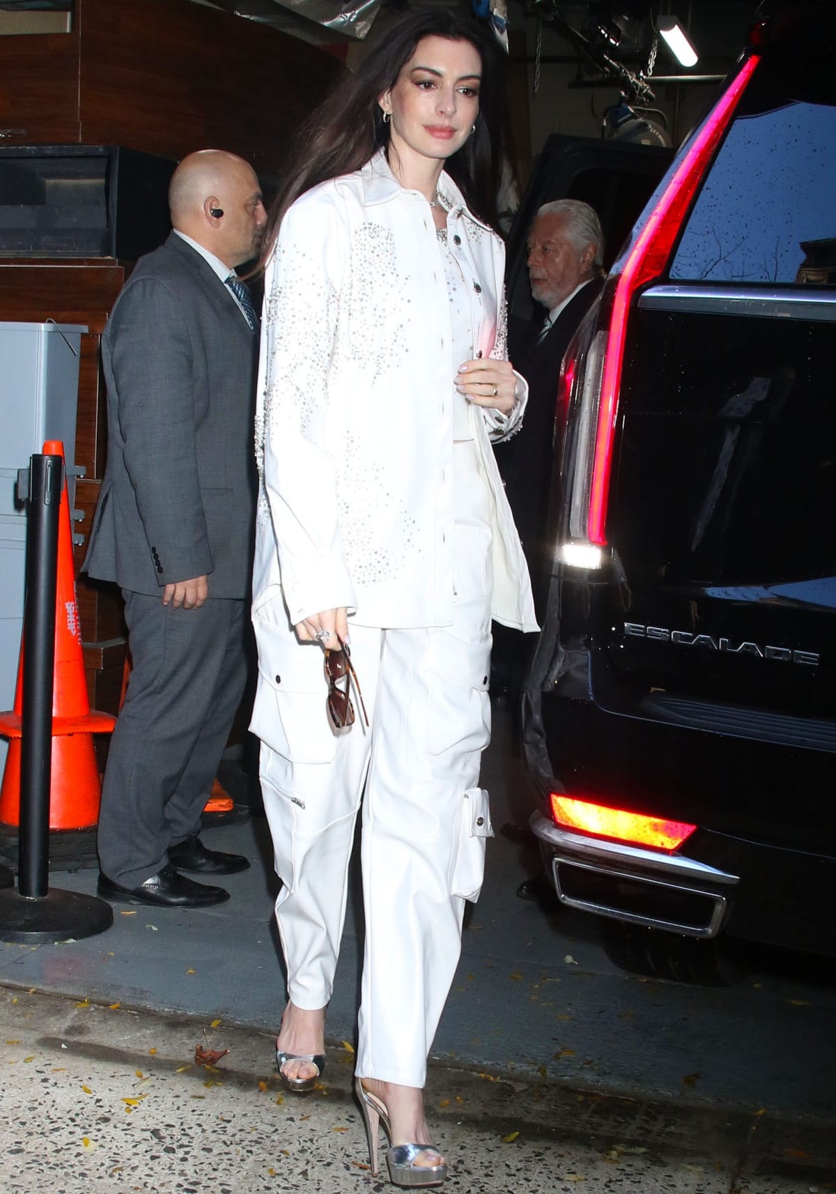 Anne Hathaway wearing silver high-heeled sandals for a stylish boost to her frame