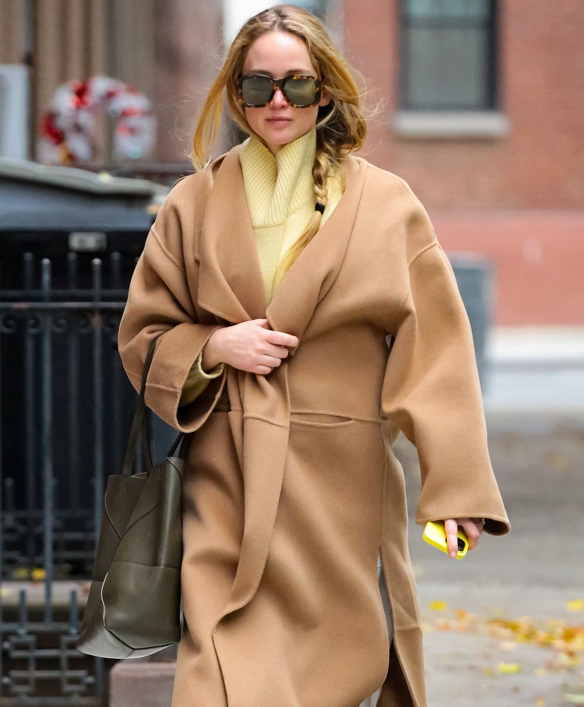 Jennifer Lawrence’s beauty look consisted of a loose side braid, minimal makeup, and Stella McCartney oversized square sunglasses