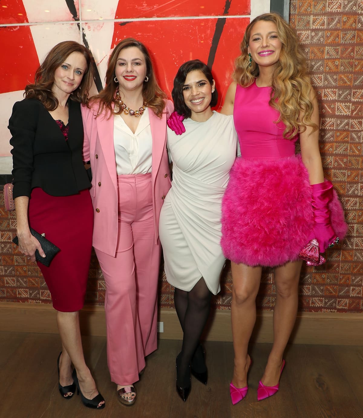 Posing with Alexis Bledel, Amber Tamblyn, and America Ferrera, Blake Lively dazzles in a fuchsia Oscar de la Renta feather-skirt mini dress, epitomizing Barbiecore elegance