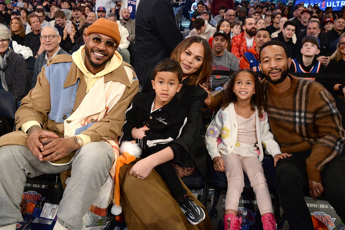 Chrissy Teigen and family pose for photos with former NBA player Carmelo Anthony