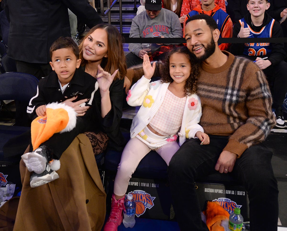 Chrissy Teigen, John Legend, and kids Miles and Luna watch the home team New York Knicks beat the visiting Milwaukee Bucks 129-122 at Madison Square Garden on December 25, 2023