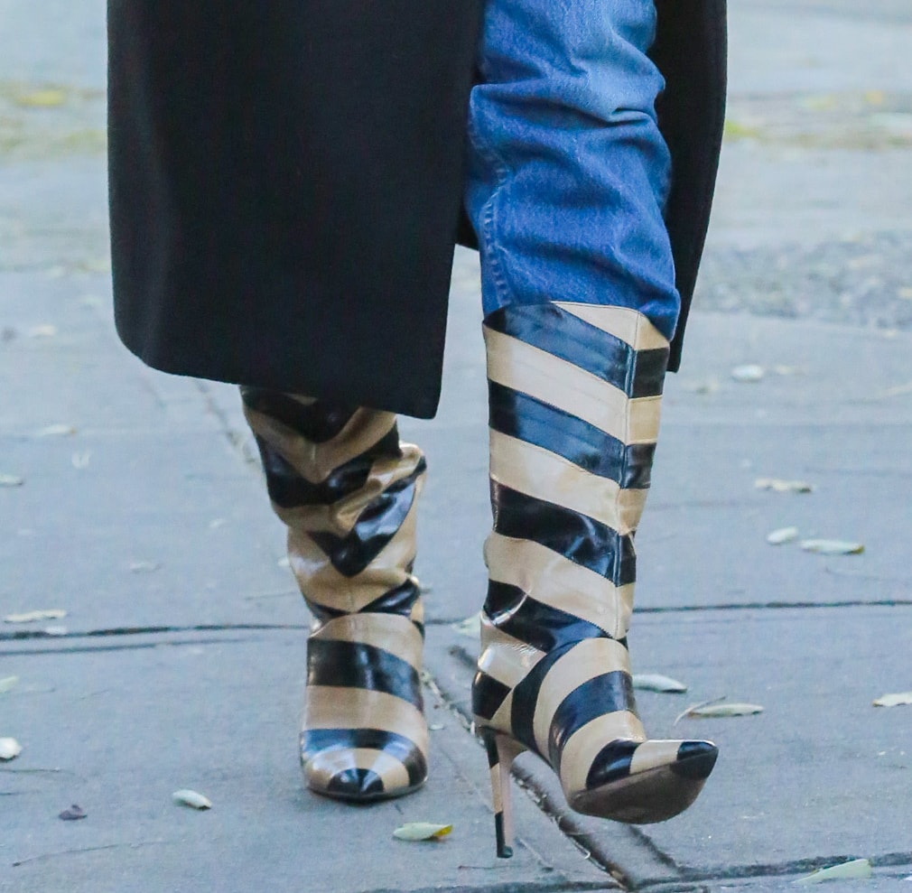 Emily Ratajkowski adds a quirky element to her sophisticated winter outfit by wearing the striped "Beren" boots by Jimmy Choo
