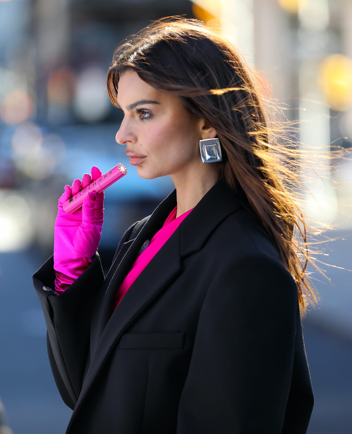 Emily Ratajkowski styles her traffic-stopping cutout jumpsuit with chunky Heaven Mayhem earrings and highlights her features with fake lashes and pink lip gloss