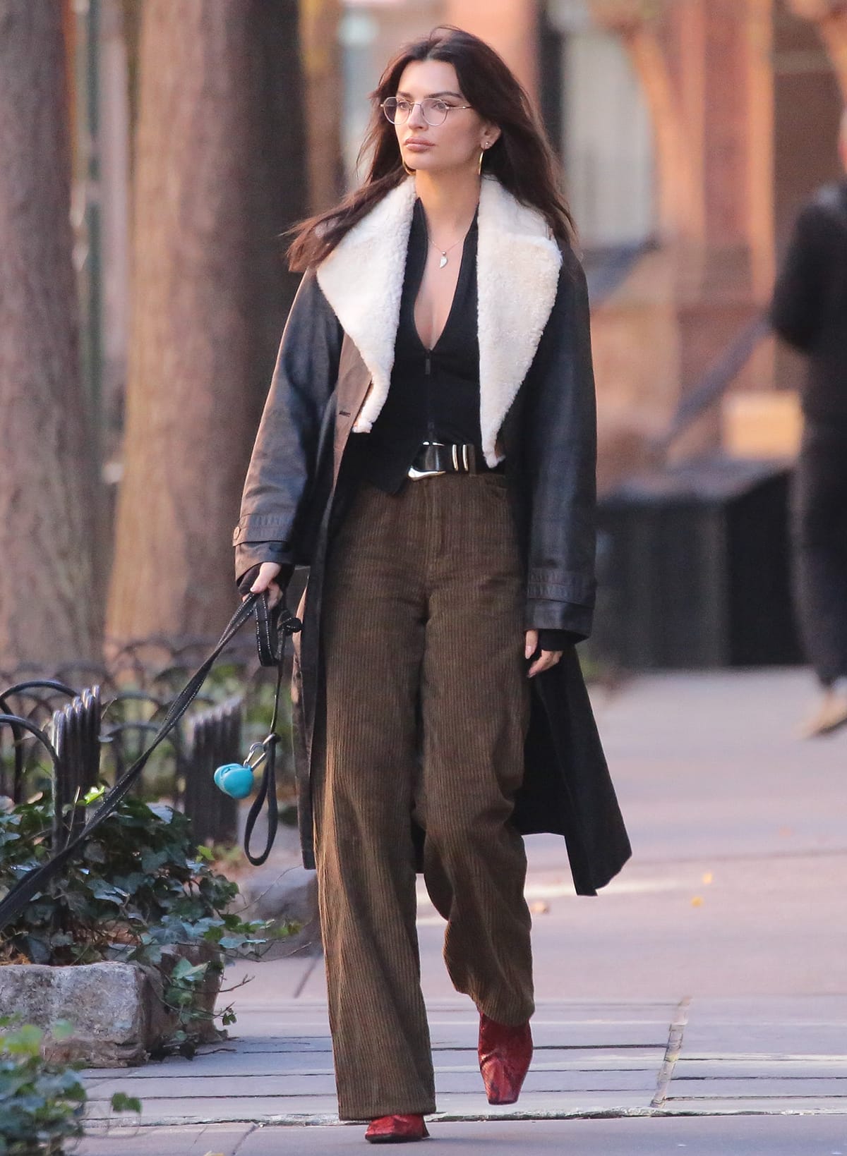 Emily Ratajkowski teams her neutral-colored ensemble with bright red python boots with square toes by Celine