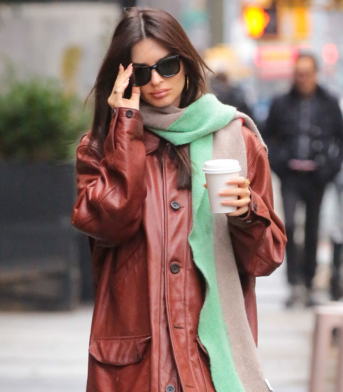 Emily Ratajkowski styles her winter look with Jennifer Fisher hoop earrings and Ray-Ban Wayfarers