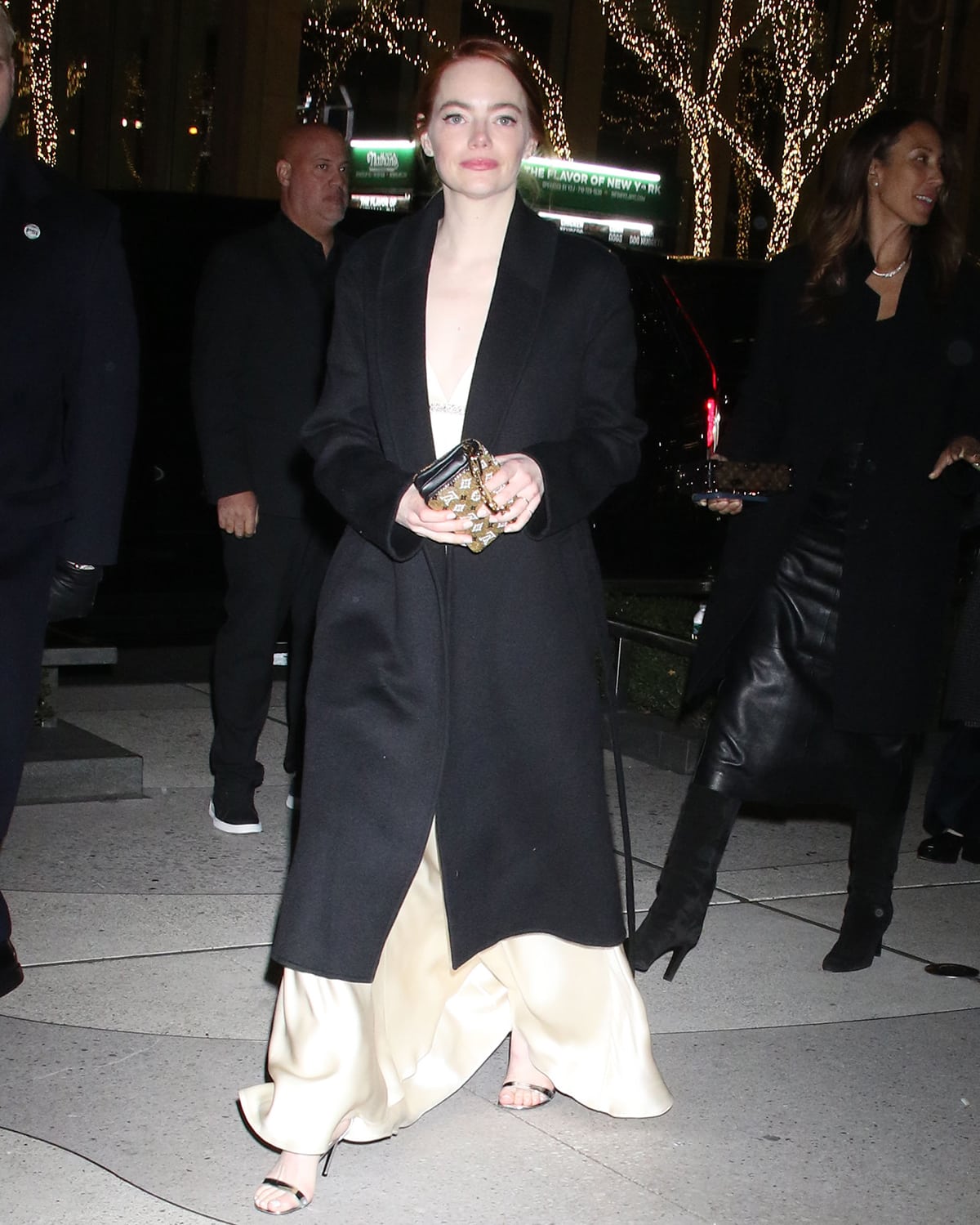 Emma Stone swaps her see-through yellow dress for a plunging slip dress as she attends the Poor Things premiere after-party at AVRA Estiatorio