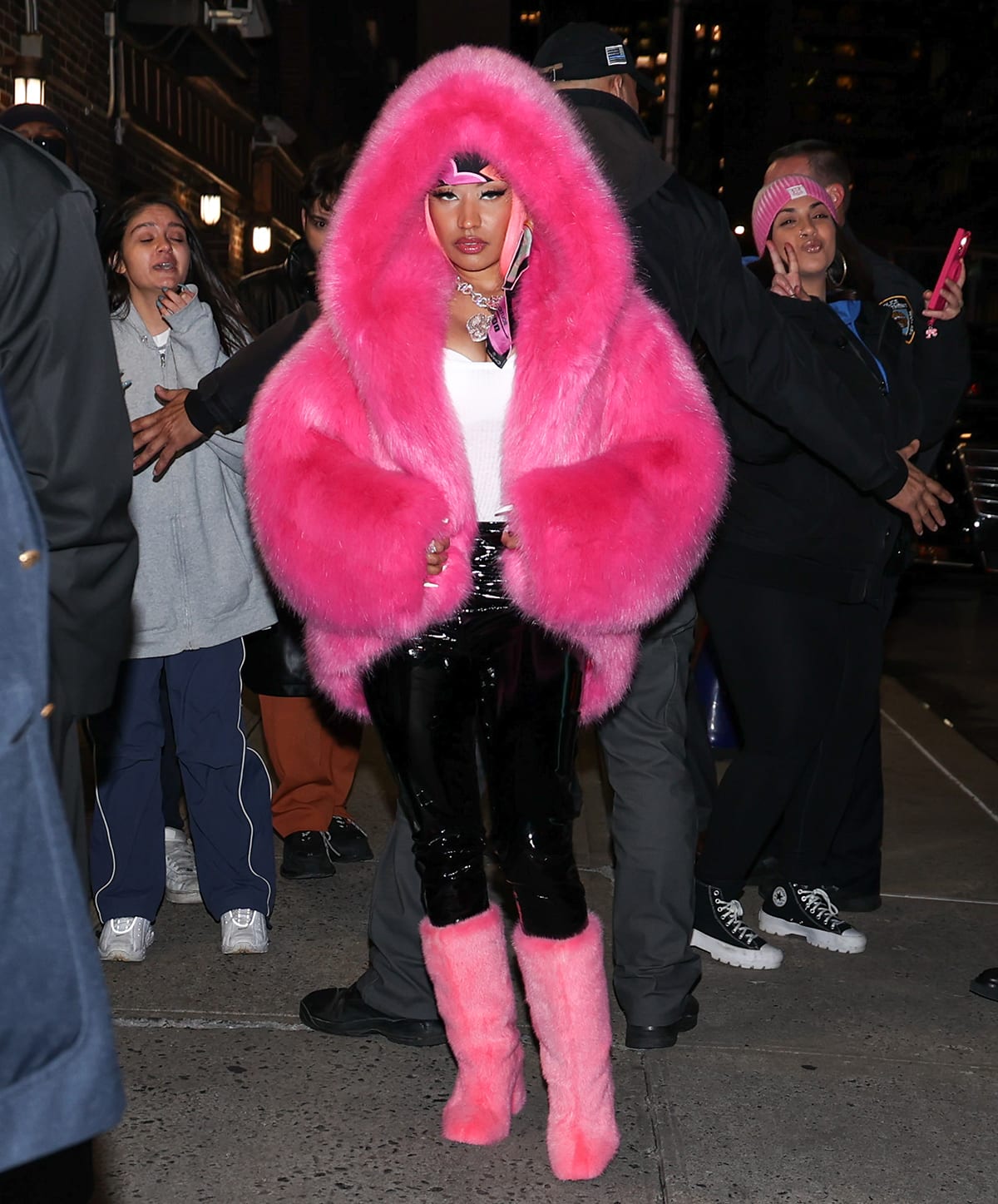 Nicki Minaj promotes her Pink Friday 2 album and upcoming world tour in a fluffy pink coat by Alexandre Vauthier, black latex pants, and pink mink boots at The Late Show With Stephen Colbert in New York City on December 11, 2023
