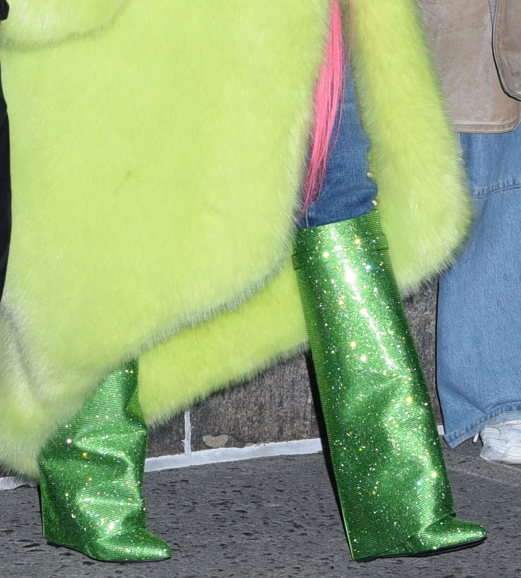 Nicki Minaj completes her colorful winter look with green crystal-embellished Shark Lock knee-high boots by Givenchy