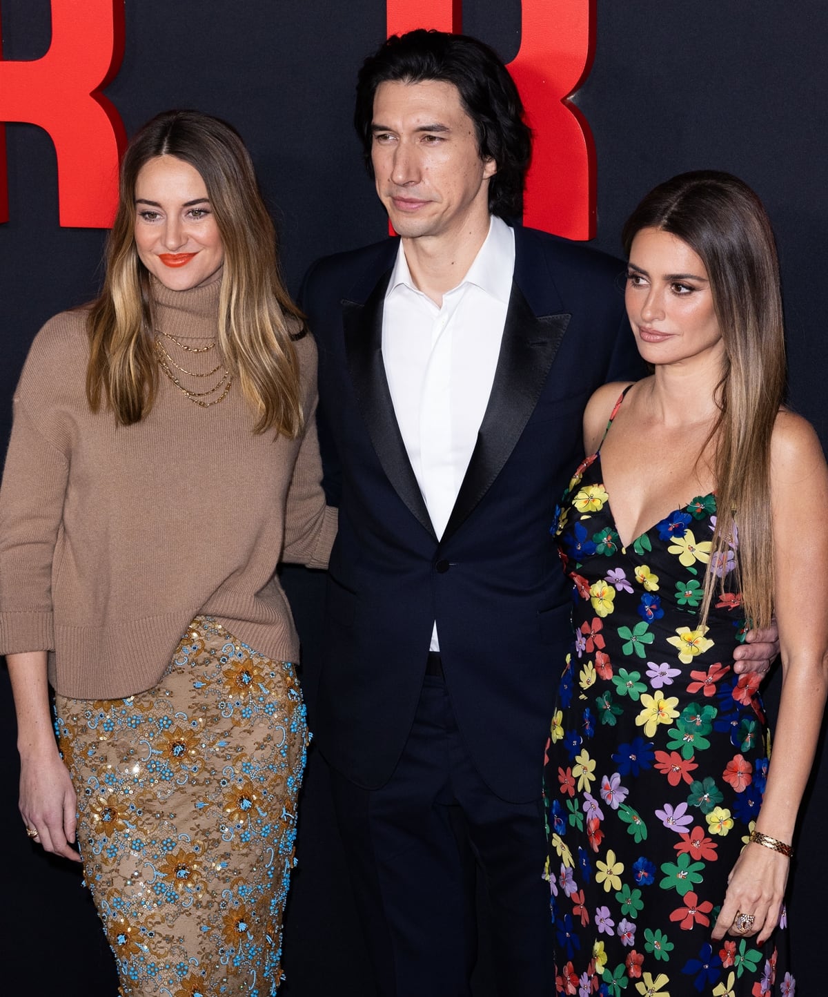 Adam Driver, standing tall at 6ft 2 ¼ inches (188.6 cm), towers over Penelope Cruz (5ft 4 inches, 162.6 cm) and Shailene Woodley (5ft 7 ¾ inches, 172.1 cm) on the red carpet, highlighting the striking height difference among the 'Ferrari' film's stars
