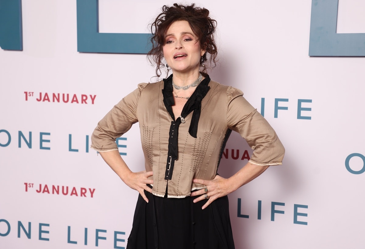 Helena Bonham Carter’s beauty look consisted of pink eye makeup, a pearl arrow necklace, a silver diamante choker, dangling pearl earrings, and brunette curls styled in an elegant updo