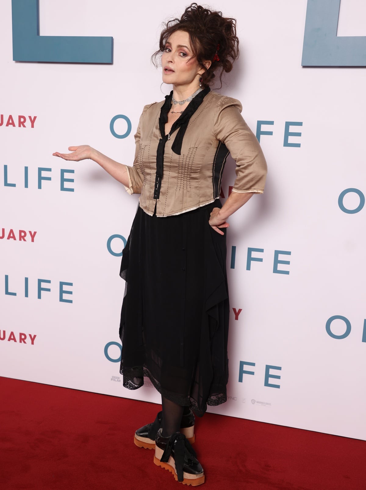 Helena Bonham Carter wearing platform black brogues with brown soles to complement her outfit
