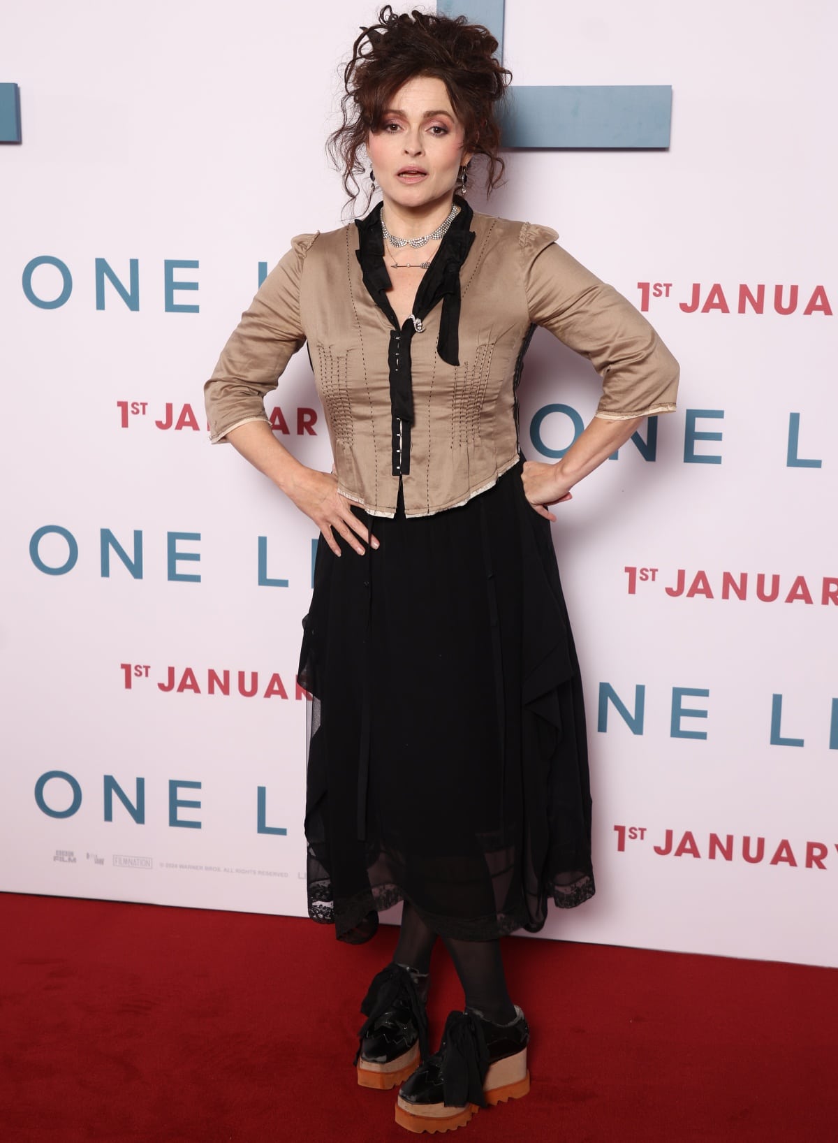 Helena Bonham Carter wearing a beige silk blouse and a black skirt at the special screening of One Life
