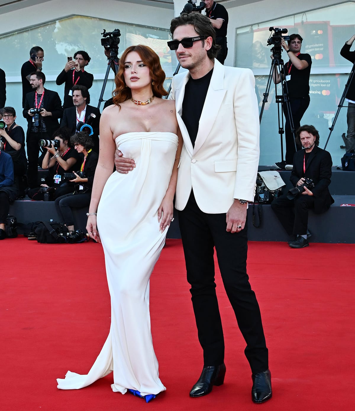 Bella Thorne and fiancé Mark Emms coordinate in white at the Priscilla premiere during the 80th Venice International Film Festival on September 4, 2023