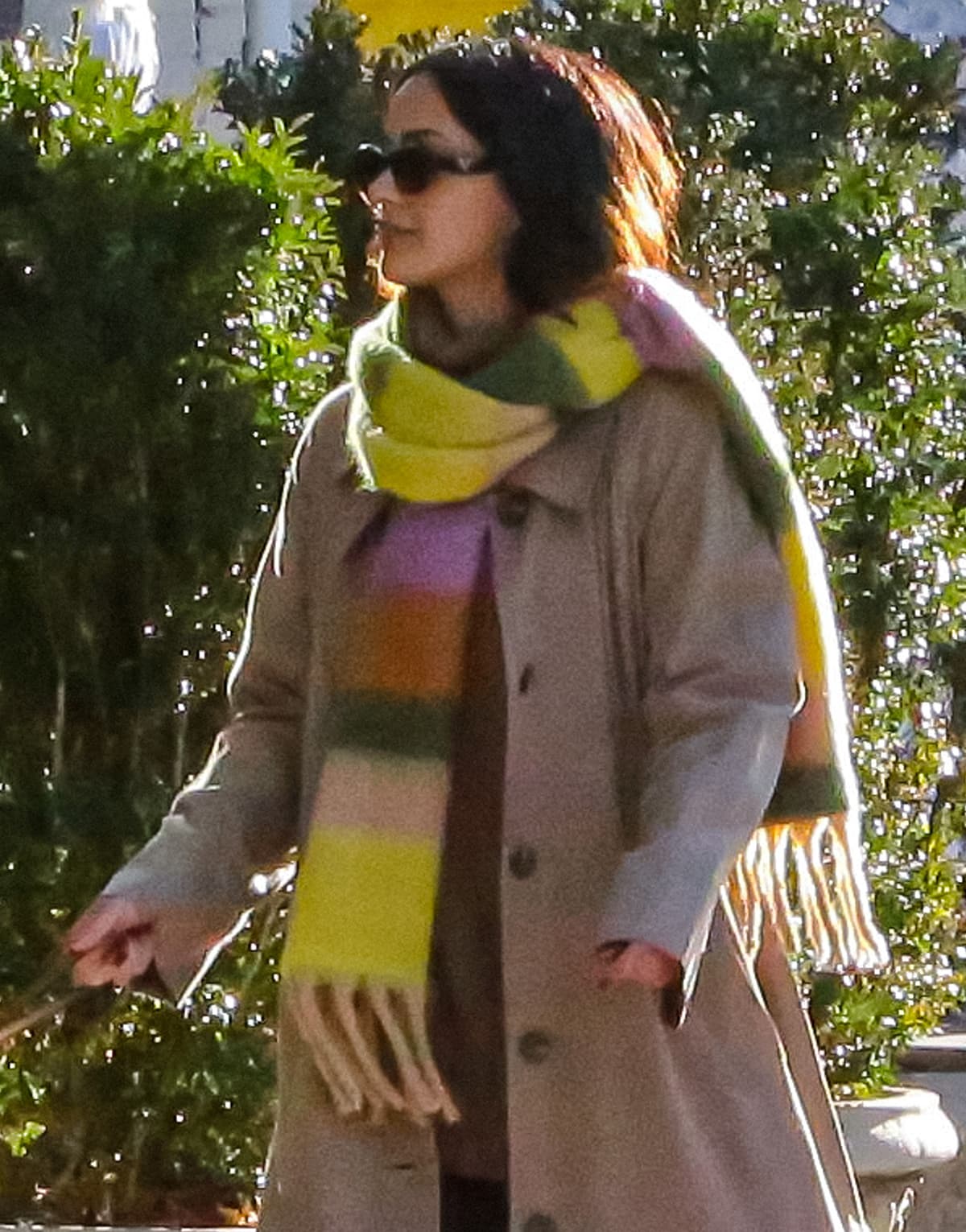 Camila Mendes styles her casual but chic winter look with Prada Symbole sunglasses, Levi's jeans, and Adidas chunky sneakers