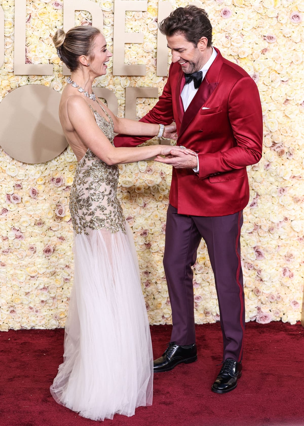 At the 2024 Golden Globes, Emily Blunt glowed in a gold Alexander McQueen gown alongside John Krasinski, who complemented her in a sharp Dolce & Gabbana red suit