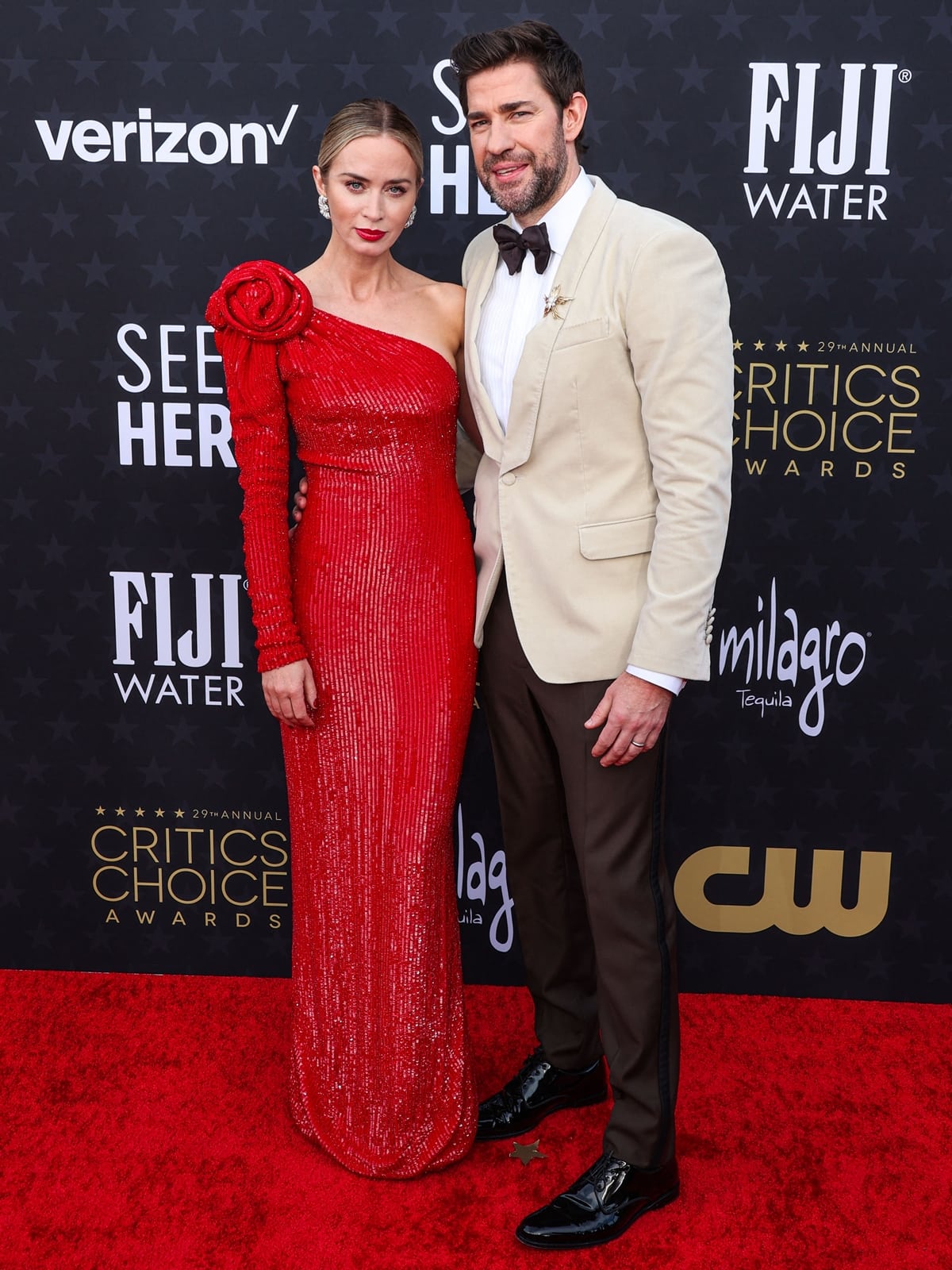 Emily Blunt and John Krasinski radiate Hollywood glamour at the 29th Annual Critics Choice Awards in Santa Monica, with Emily in a stunning Armani Privé gown and John in a sleek off-white suit jacket