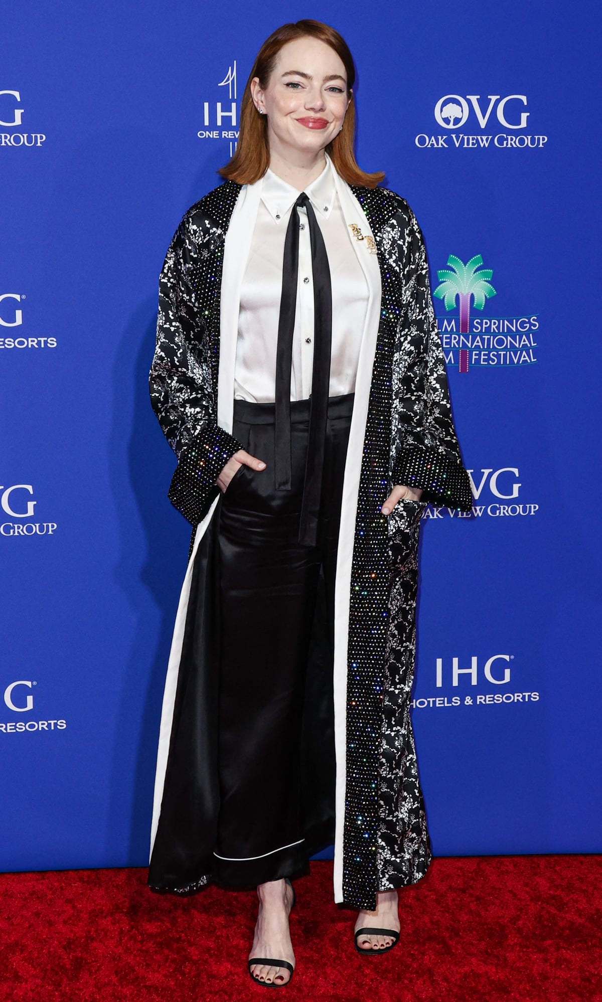 Emma Stone captivates on the red carpet in her custom black-and-white Louis Vuitton ensemble, a blend of modern chic and timeless elegance