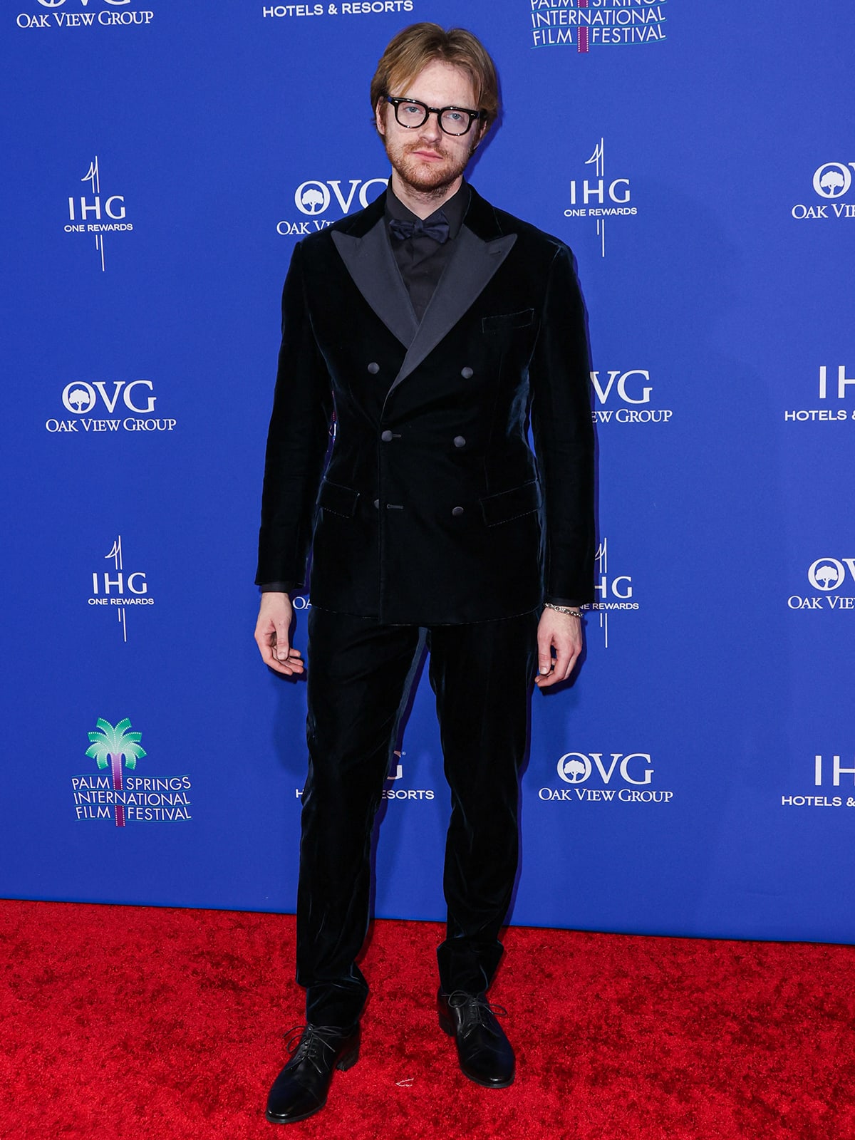 Finneas Baird O'Connell looks dapper in a black velvet suit, matching trousers, and a black shirt with a black bowtie