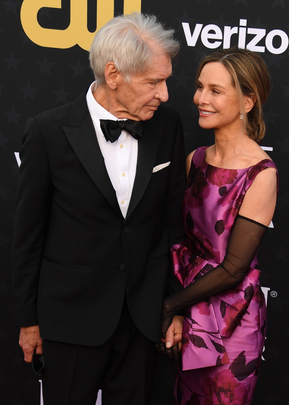 The inseparable couple, Harrison Ford and Calista Flockhart, exchange loving glances while elegantly dressed, celebrating years of togetherness at the 29th Annual Critics Choice Awards at Barker Hangar on January 14, 2024 in Santa Monica, California