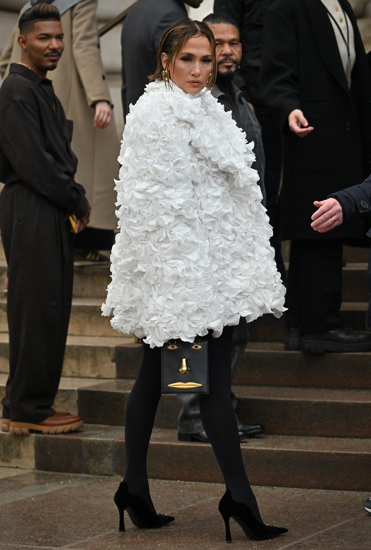 Jennifer Lopez's Skeleton Trompe-L’oeil knit turtleneck, inspired by dove wings, and an ethereal white coat adorned with real rose petals, stole the show at the Schiaparelli Haute Couture Spring/Summer 2024 show as part of Paris Fashion Week on January 22, 2024 in Paris, France